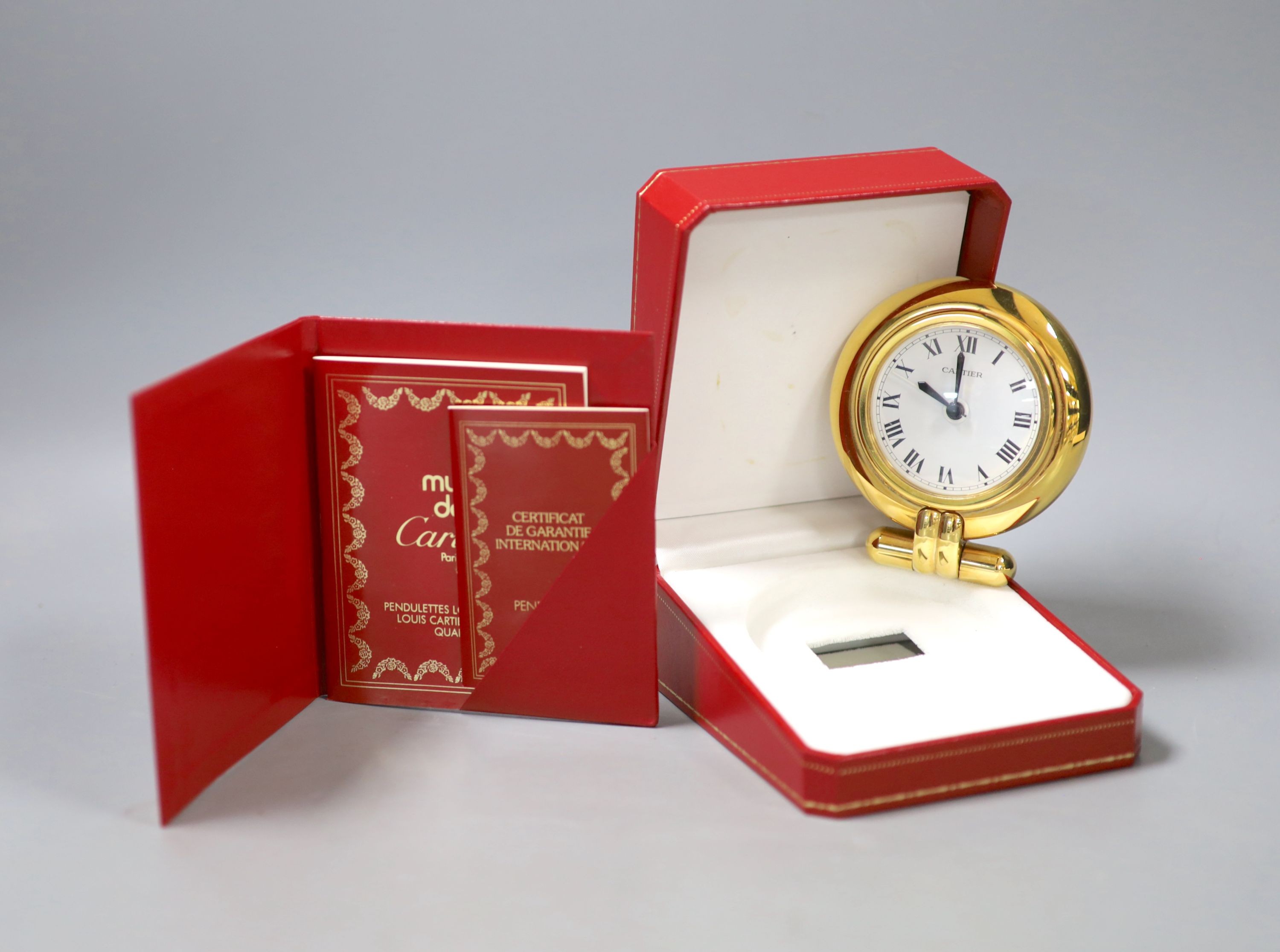 A cased Cartier gilt metal travelling timepiece